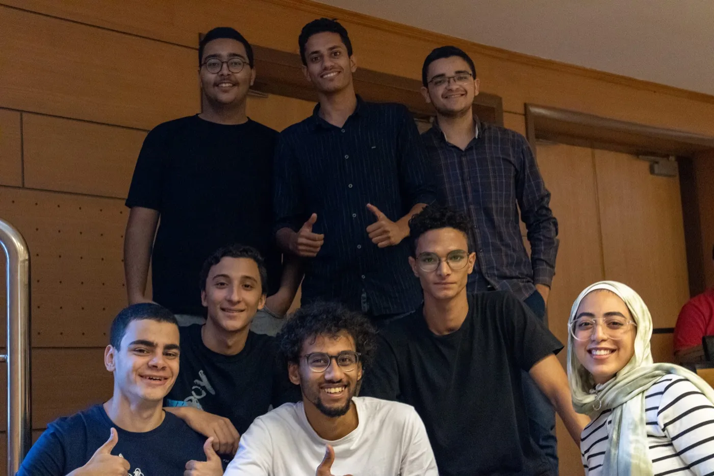 Nine members of the NUICPC committee posed on a staircase